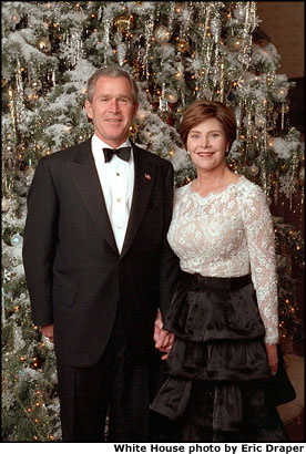 President George W. Bush and Mrs. Bush pose for their Christmas portrait in the Blue Room in front of the official White House Christmas Tree Dec. 2. White House photo by Eric Draper.