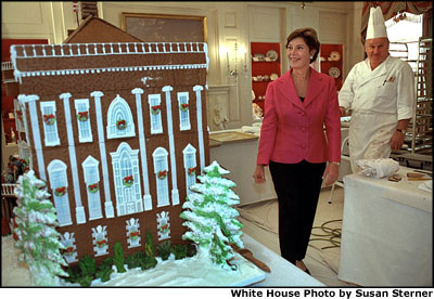 Mrs. Bush takes a sneak preview at White House Pastry Chef Roland Mesnier's gingerbread creation Dec. 2. Built from more than 80 pounds of gingerbread, it is a re-creation of the original White House as it appeared in 1800 when John Adams became the first resident. White House photo by Susan Sterner.