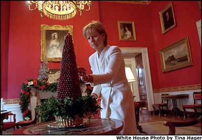White House Assistant Chief Florist Wendy Elsasser carefully checks each berry of the Red Room Cranberry. Exacting four days of patient care, the tree is a 19-year White House tradition. White House photo by Tina Hager.