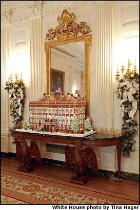 Placed in the State Dinning Room, the gingerbread house is a replica of the White House of 1800 when John Adams became the first Presidential resident. Original floor plans were used, but history was fudged a little to allow President Bush’s pets Spot, Barney and India frolic on the grounds. Constructed from more than 80 pounds of gingerbread, 30 pounds of chocolate and 20 pounds of marzipan, the sweet home took more than three weeks to build. White House photo by Tina Hager