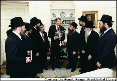 President Reagan receives a menorah in the Oval Office from "Friends of Lubavitch" in 1986. Photo Courtesy the Ronald Reagan Presidential Library