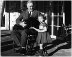 President Franklin D. Roosevelt (1933-45) introduces his Scottish terrier, Fala, to a young girl. 