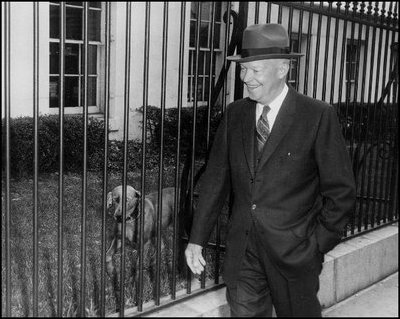 President Dwight Eisenhower walks by Heidi, his Weimaraner, as he returns to the White House following a press conference on March 11, 1959 at the Executive Office Building, which today is named the Eisenhower Executive Office Building in memory of the 34th president.