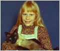 Amy Carter, daughter of Jimmy Carter (1977-81), holds her Siamese cat, Misty Malarky Ying Yang.