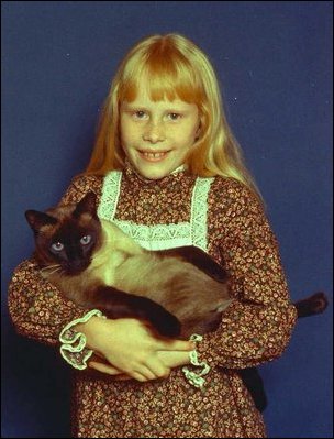 Amy Carter, daughter of Jimmy Carter (1977-81), holds her Siamese cat, Misty Malarky Ying Yang. 