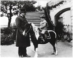 A White House policeman helps young Quentin Roosevelt by holding the reins of Algonquin, a calico pony, in 1902.
