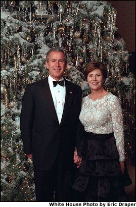The President and Mrs. Bush stand in front of the White House Christmas Tree.