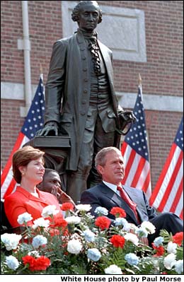Sitting in front of Independence Hall, July 4, 2001, President Bush and Laura Bush listen to fellow speakers during the celebration ceremonies. White House photo by Paul Morse