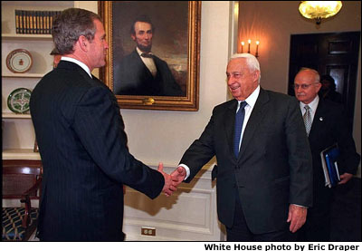 President Bush and Prime Minister Ariel Sharon shake hands in the Oval Office. White House photo by Eric Draper.