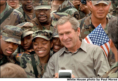 While visiting Camp Bondsteel, President Bush took time to eat lunch with the troops and pose for pictures. White House photo by Paul Morse.