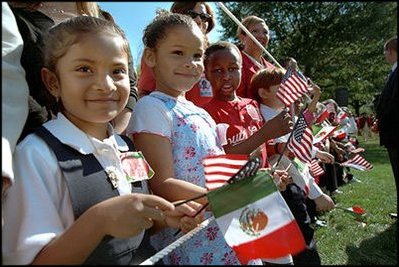 Waving little flags of our two neighboring nations, future VIP's watch the ceremonies.