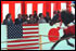 Prime Minister Junichiro Koizumi, far left, President George W. Bush, left, Laura Bush, second right, and Kiyoko Fukuda, far right, wife of the Japanese chief cabinet secretary, watch a demonstration of horseback archery during a visit to the Meiji Shrine in Tokyo, Monday, Feb. 18, 2002. White House photo by Susan Sterner.