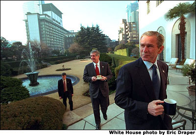 President George W. Bush and White House Chief of Staff Andy Card (center), take their morning coffee in the garden at the residence of United States' ambassador Howard Baker in Tokyo, Monday, Feb. 18, 2002. White House photo by Eric Draper.