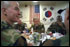 During his tour of Observation Post Oullette, President George W. Bush eats lunch with troops Wednesday, Feb. 20, 2002. White House photo by Eric Draper.