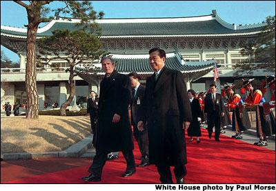 President George W. Bush and President Kim Dae-Jung proceed through an arrival ceremony at the Blue House in Seoul, South Korea, Feb. 20, 2002. White House photo by Paul Morse.