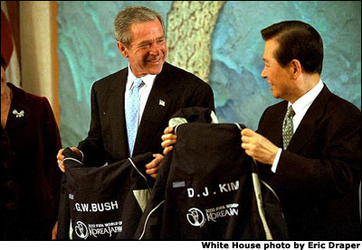 President George W. Bush and South Korean President Kim Dae-Jung show off their souvenir jackets from the World Cup committee during a reception at the Blue House, in Seoul, South Korea, Wednesday, Feb. 20, 2002. This year the World Cup soccer championships will be held in South Korea and Japan. White House photo by Eric Draper.