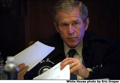 Meeting with senior staff aboard Air Force One, President George W. Bush prepares for his meeting with Chinese President Jiang Zemin while en route from South Korea to Beijing, China, Thursday, Feb. 21, 2002. White House photo by Eric Draper.