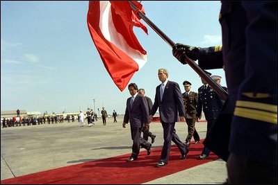 President George W. Bush and Peruvian President Alejandro Toledo participate in the arrival ceremony at the Jarez Chavez International Airport in Cullao, Peru, Saturday, March 23, 2002. The first sitting President to visit Peru, President Bush announced several aggressive programs designed to build a strong relationship between America and Peru. White House photo by Eric Draper