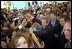 President George W. Bush greets enthusiastic crowds in Lima, Peru, Saturday, March 23, 2002. During his historic visit, President Bush announced specific programs to bring Americans and Peruvians together, such as sending the Peace Corps to the region. White House photo by Eric Draper