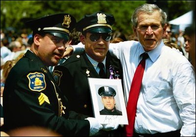President George W. Bush stands for pictures during the Annual Peace Officers' Memorial Service at the U.S. Capitol in Washington, D.C., Saturday, May 15, 2004. "Our fallen officers died in service to justice, and in defense of the innocent," said President Bush. "They will never be forgotten by their comrades, they will never be forgotten by their country." 
