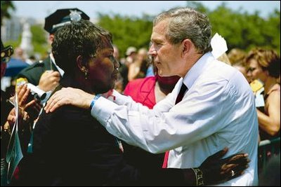 President George W. Bush talks with a woman attending the Annual Peace Officers' Memorial Service at the U.S. Capitol in Washington, D.C., Saturday, May 15, 2004. 