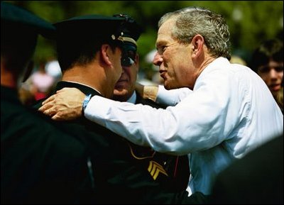 President George W. Bush talks with officers at the Annual Peace Officers' Memorial Service at the U.S. Capitol in Washington, D.C., Saturday, May 15, 2004. 