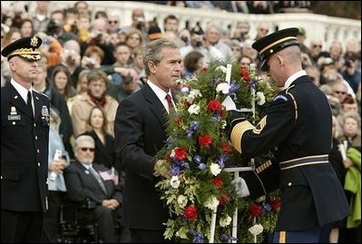 Honoring those who died in service to America, President George W. Bush lays a wreath at the Tomb of the Unknowns in Arlington Cemetery on Veterans Day Nov. 11, 2003. After the wreath was placed, "Taps" was played and a moment of silence was observed.