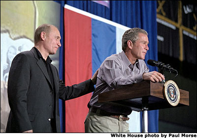 President George W. Bush and Russian President Vladimir Putin answer questions from students at Crawford High School Nov. 15. "When I was in high school, Russia was an enemy," said President Bush. "Now the high school students can know Russia as a friend; that we're working together to break the old ties, to establish a new spirit of cooperation and trust so that we can work together to make the world more peaceful." White House photo by Paul Morse.