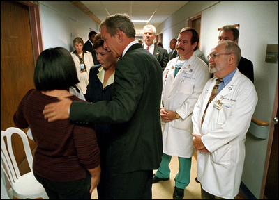 President Bush and Mrs. Laura Bush comfort family members at Washington Hospital Center Sept. 13. The President and First Lady visited the hospital to thank doctors and visit patients wounded in the attack on the Pentagon.