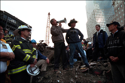 Standing upon the ashes of the worst terrorist attack on American soil Sept. 14, President Bush pledges that the voices calling for justice from across the country will be heard. Responding to the Presidents' words, rescue workers cheer and chant, "U.S.A, U.S.A."