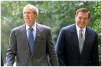 President Bush and Governor Ridge walk together on the South Lawn of the White House Sept. 19, 2002.