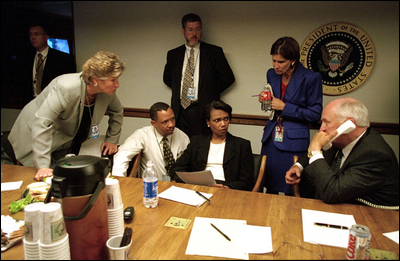 Vice President Dick Cheney talks with President Bush as senior staff listen from the National Presidential Emergency Operations Center Sept. 11, 2001.