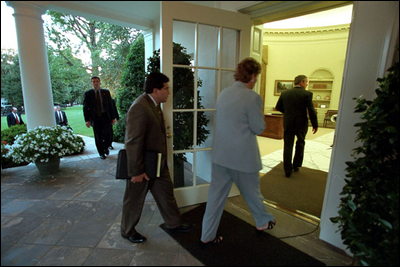 President George W. Bush returns to the White House followed by White House Counsel Alberto Gonzales and Counselor Karen Hughes Sept. 11, 2001.