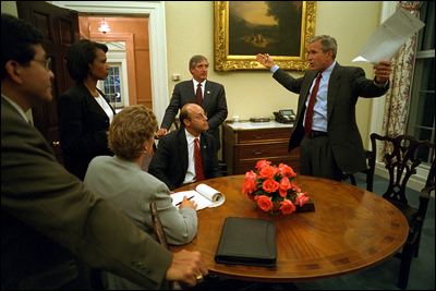 Returning from Sarasota, Fla., where he first saw news footage of the attack, President George W. Bush immediately gathers his senior staff in the private dining room off the Oval Office Sept. 11, 2001. Meeting with the President from left to right are White House Counsel Alberto Gonzales, Counselor Karen Hughes, National Security Advisor Dr. Condoleezza Rice, Press Secretary Ari Fleischer and Chief of Staff Andy Card.