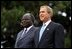 Presidents Bush and Kibaki watch the military review portion of the State Arrival Ceremonies on the South Lawn of the White House Monday, October 5, 2003.