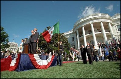 President Bush pledges allegiance during the playing of the National Anthem as Mexican President Vicente Fox stands at attention during the State Arrival Ceremony on the White House South Lawn Sept. 6.