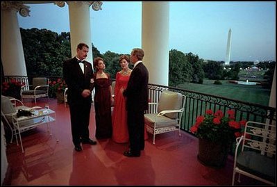 Mexican President Vicente Fox and his wife Martha Sahagun de Fox talk privately with President Bush and First Lady Laura Bush on the Truman Balcony of the White House before greeting guests at the state dinner Wednesday evening. After the dinner, the two couples and their friends watched fireworks from the balcony.