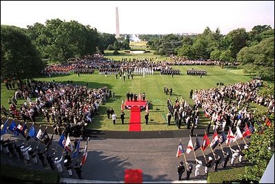 President George W. Bush and Laura Bush stand with visiting President Aleksander Kwasniewski of Poland and his wife, Jolanta Kwasniewska, during the State Arrival Ceremony on the South Lawn Wednesday, July 17, 2002. White House photo by Paul Morse.
