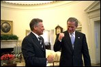 Before starting the first meeting of the day, Presidents Bush and Kwasniewski talk privately in the Oval Office July 17. White House photo by Eric Draper.