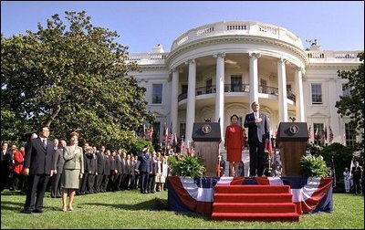 President Bush, President Arroyo, Laura Bush and Jose Miguel Arroyo, far left, stand for the playing of the national anthems of the United States and the Philippines at the beginning of the ceremony. 