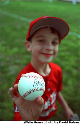 A Rockies player shows off his signed baseball from the afternoon. White House photo by David Bohrer