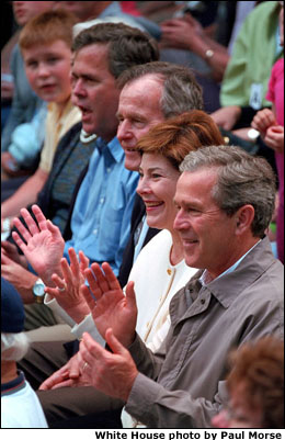 President Bush, Laura Bush, former President George Bush and the President's brother, Governor Jeb Bush, cheer on the players. White House photo by Paul Morse