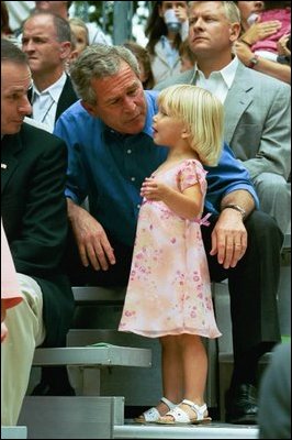 During the game, President Bush spends a few moments with a little league fan.