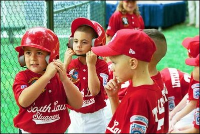 Suited up in red, the Cherry Point Marine Corps Air Station Devil Dogs prepare for their turn at bat during a game against the Bolling Air Force Base Little League Cardinals June 13, 2004. The Devil Dogs hail from Havelock, N.C., and the Cardinals are from Washington, D.C. 