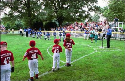 Kicking off the fourth season of White House Tee Ball, President Bush speaks during the first game of the 2004 season June 13, 2004. President Bush started the league to encourage foster a spirit of teamwork and service in America's youth.