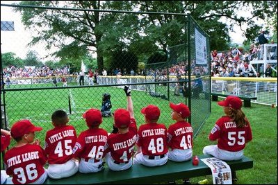 A Devil Dog cheers as a teammate rounds first base during the first game of the 2004 White House Tee Ball season June 13, 2004.