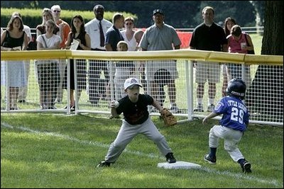 The first basemen from the Hamilton Little Lads Cal Ripken League of Hamilton, N.J., makes a play during a fast-paced game against the Milwood Little League of Kalamazoo, Mich., during the last game of the 2003 White House South Lawn Tee Ball season Sunday, Sept. 7, 2003.