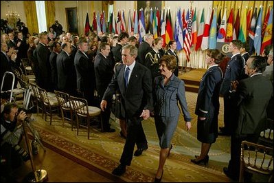 President George W. Bush and Laura Bush exit the East Room following the President's remarks commemorating the one-year anniversary of operation Iraqi Freedom and the efforts of his administration and 91 nations to ensure peace and stability in Iraq, Afghanistan and the Greater Middle East March 19, 2004.