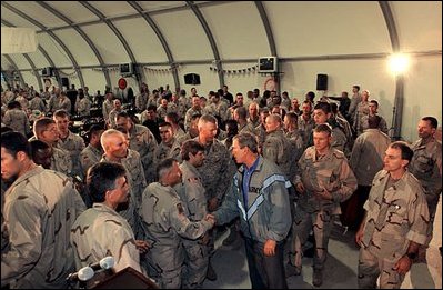 Spending Thanksgiving with some of the troops serving in Iraq, President Bush greets his fellow diners in the Bob Hope Dining Facility in Baghdad Nov. 27, 2003. "Every day you see firsthand the commitment to sacrifice that the Iraqi people are making to secure their own freedom. I have a message for the Iraqi people: you have an opportunity to seize the moment and rebuild your great country, based on human dignity and freedom," said the President in his remarks to the troops.