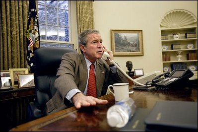 After the capture of the Iraqi dictator Saddam Hussein, President George W. Bush speaks with British Prime Minister Tony Blair during a phone call in the Oval Office, Sunday morning, Dec. 14, 2003.